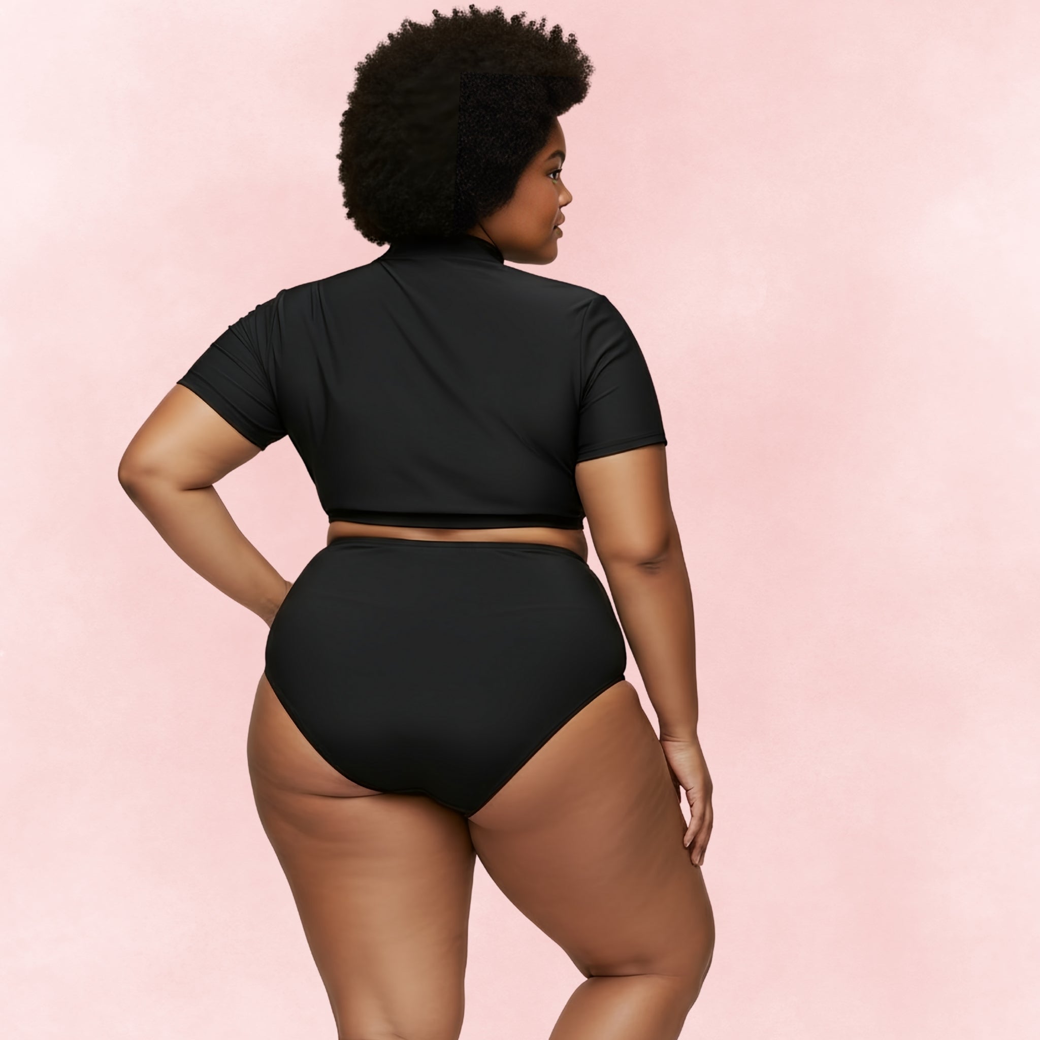Back view of plus size woman wearing black rash guard bikini set with short-sleeve zip top and high waist bottoms