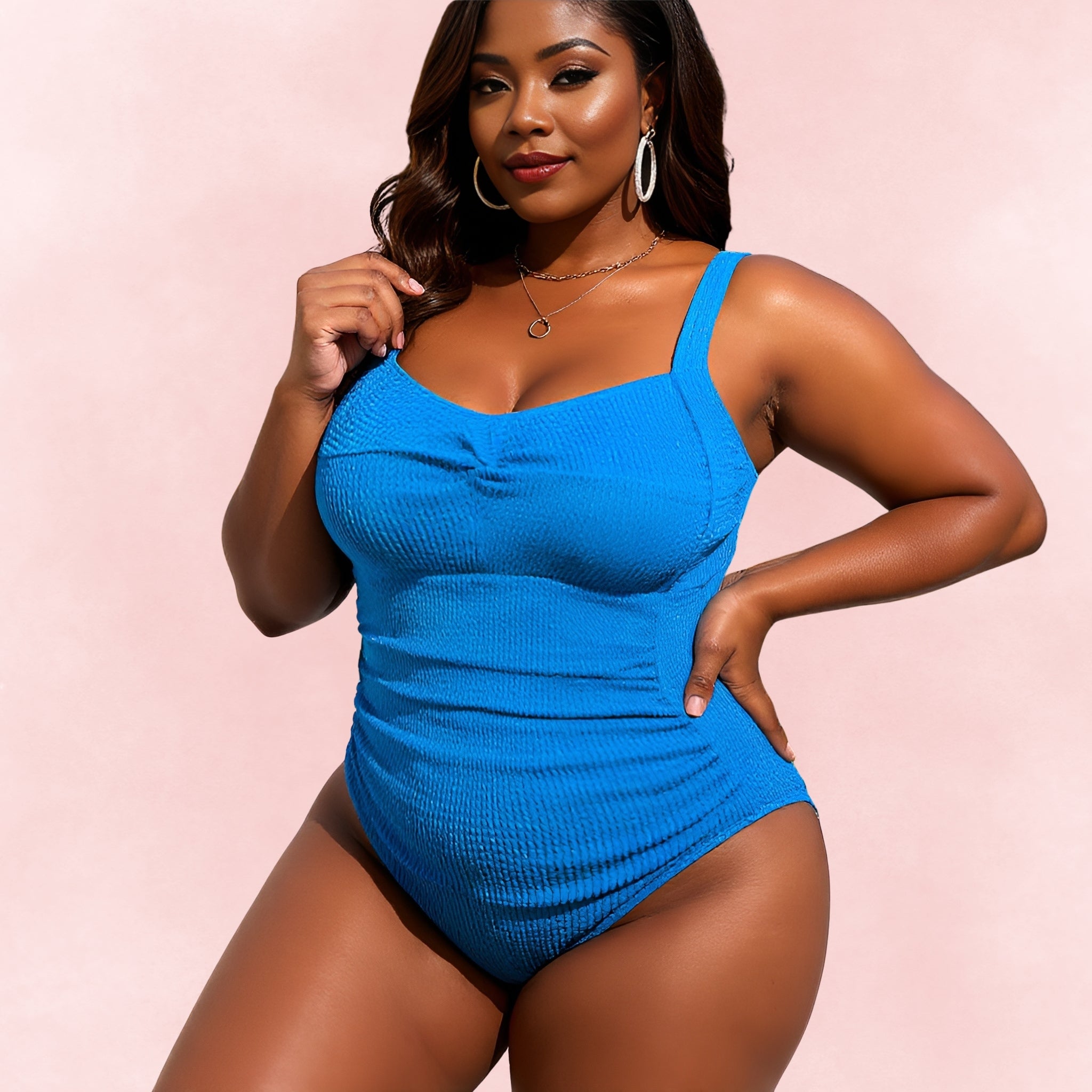 Front view of plus size woman wearing blue textured one-piece swimsuit with ruched bust detail
