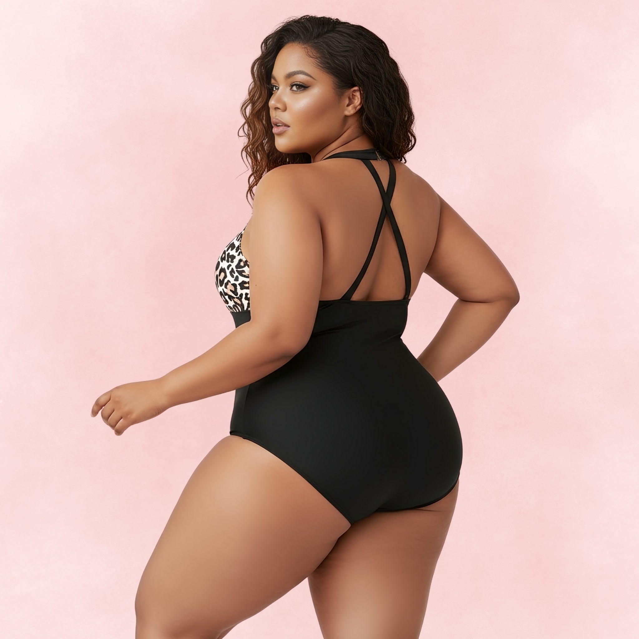 Back view of plus size woman wearing leopard print and black mesh one-piece swimsuit with crisscross straps