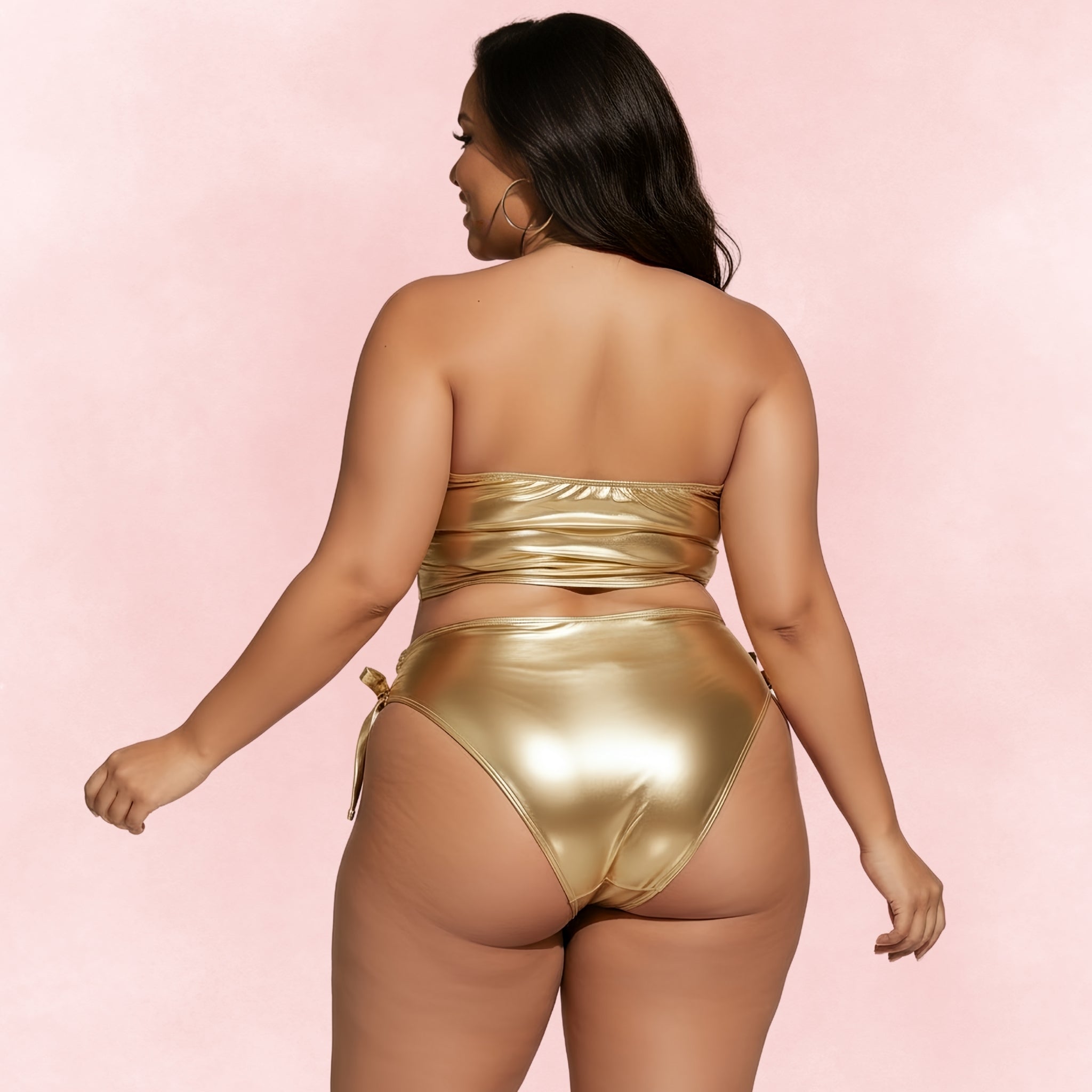 Back view of plus size woman wearing metallic gold bikini with bandeau top and high waist tie side bottoms