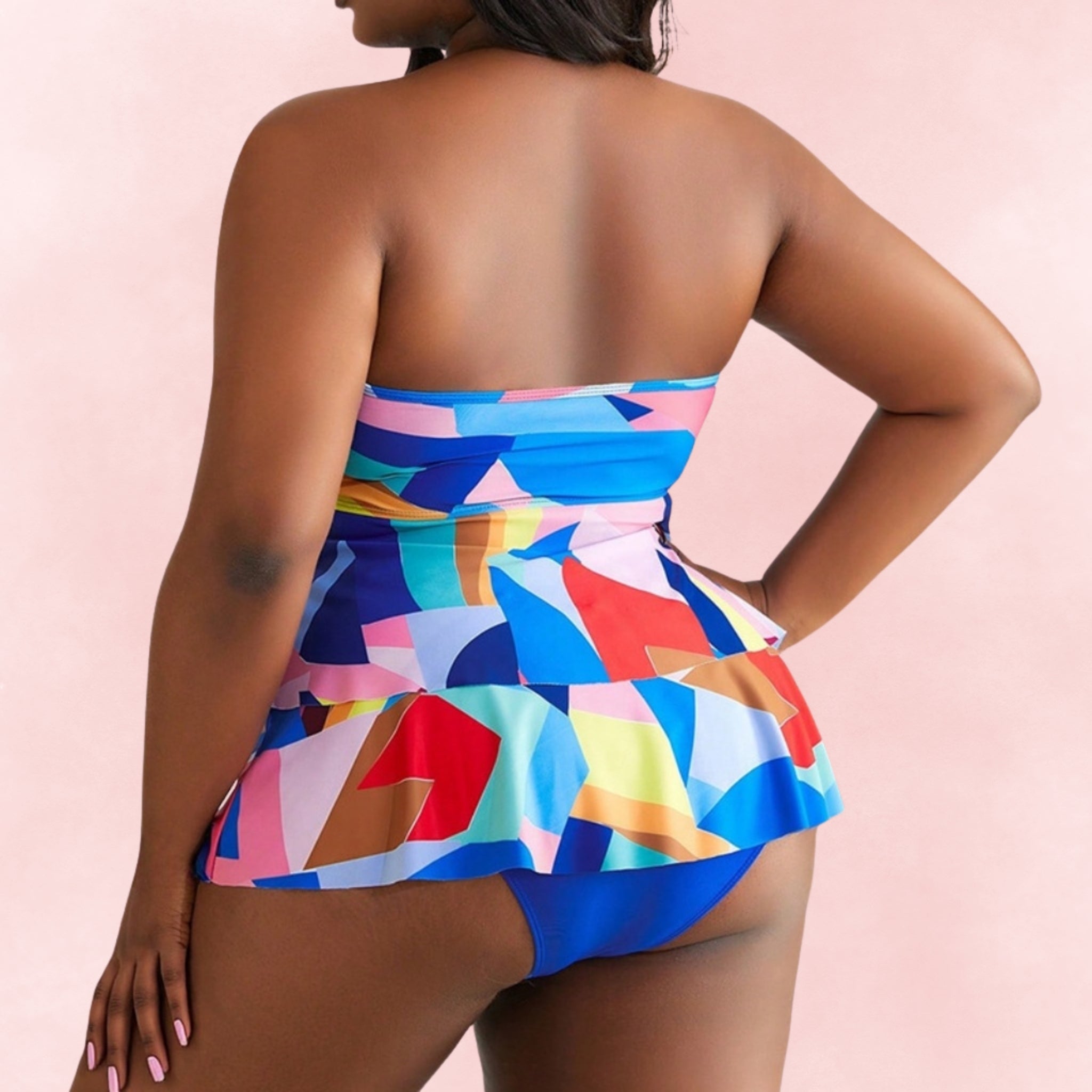 Plus size one-piece swimsuit with multicolor geometric print and skirted hem, back view