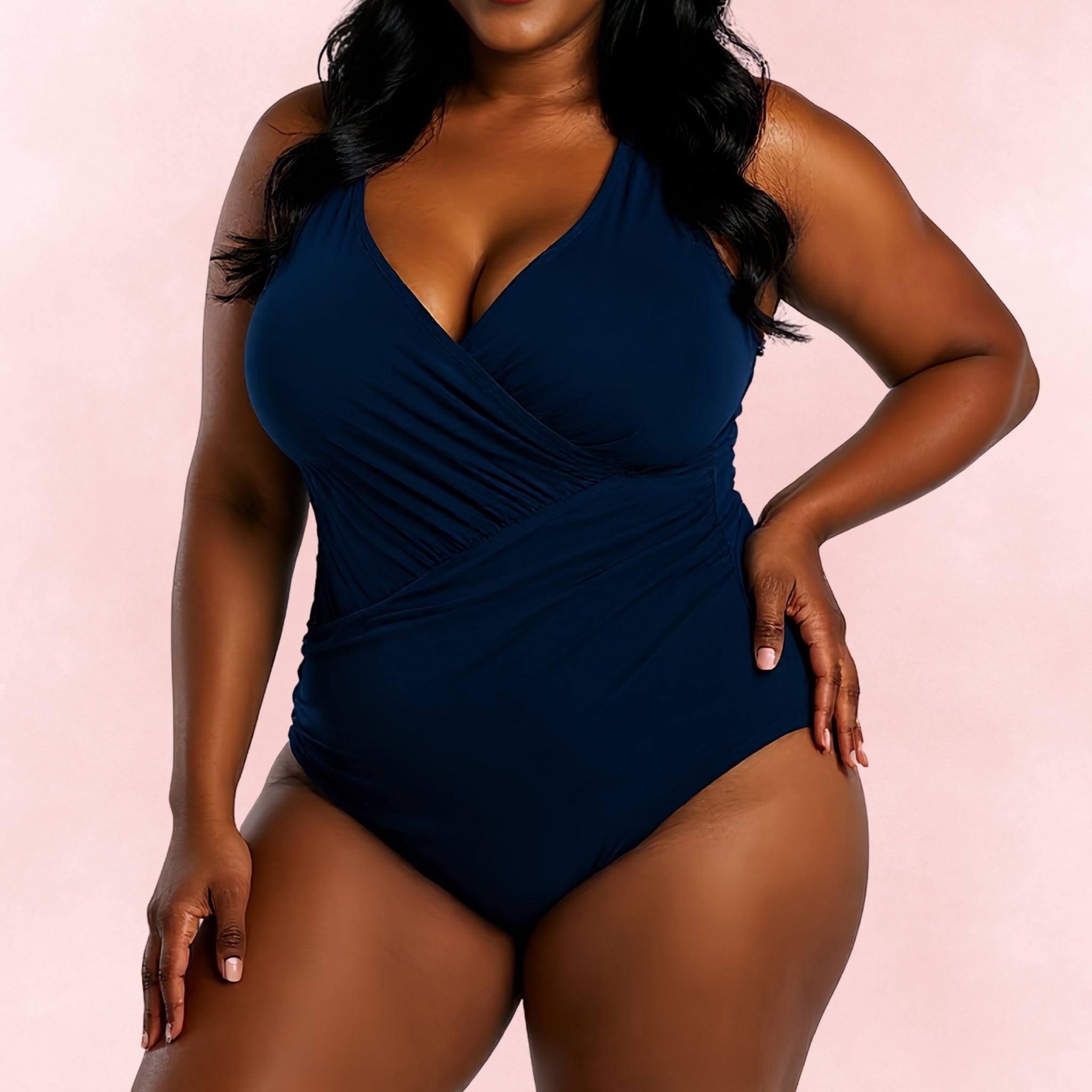 Plus size one-piece swimsuit in navy blue with wrap front design, front view