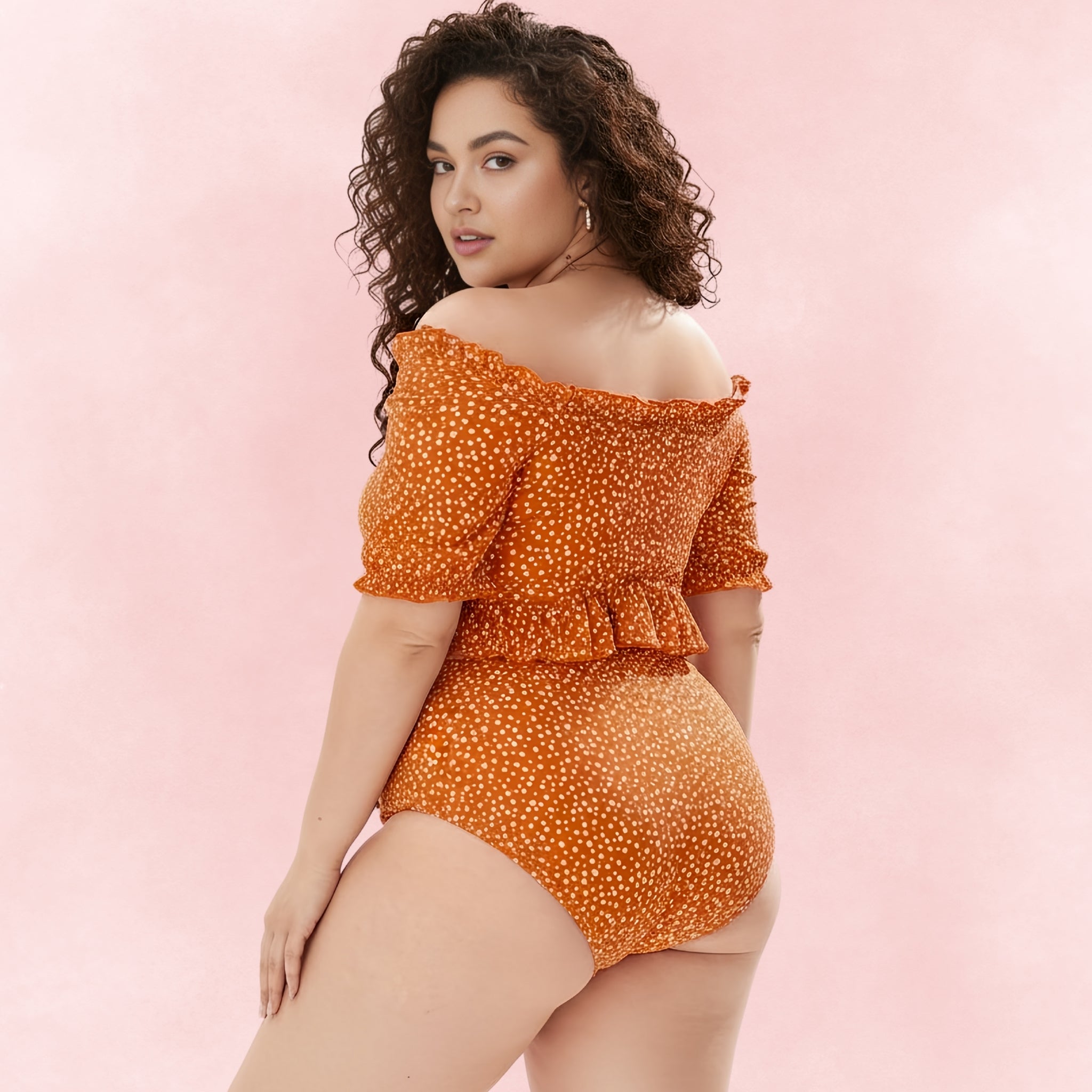 Back view of orange off-shoulder bikini with ruffled hem top and high-waisted polka-dot bottoms.