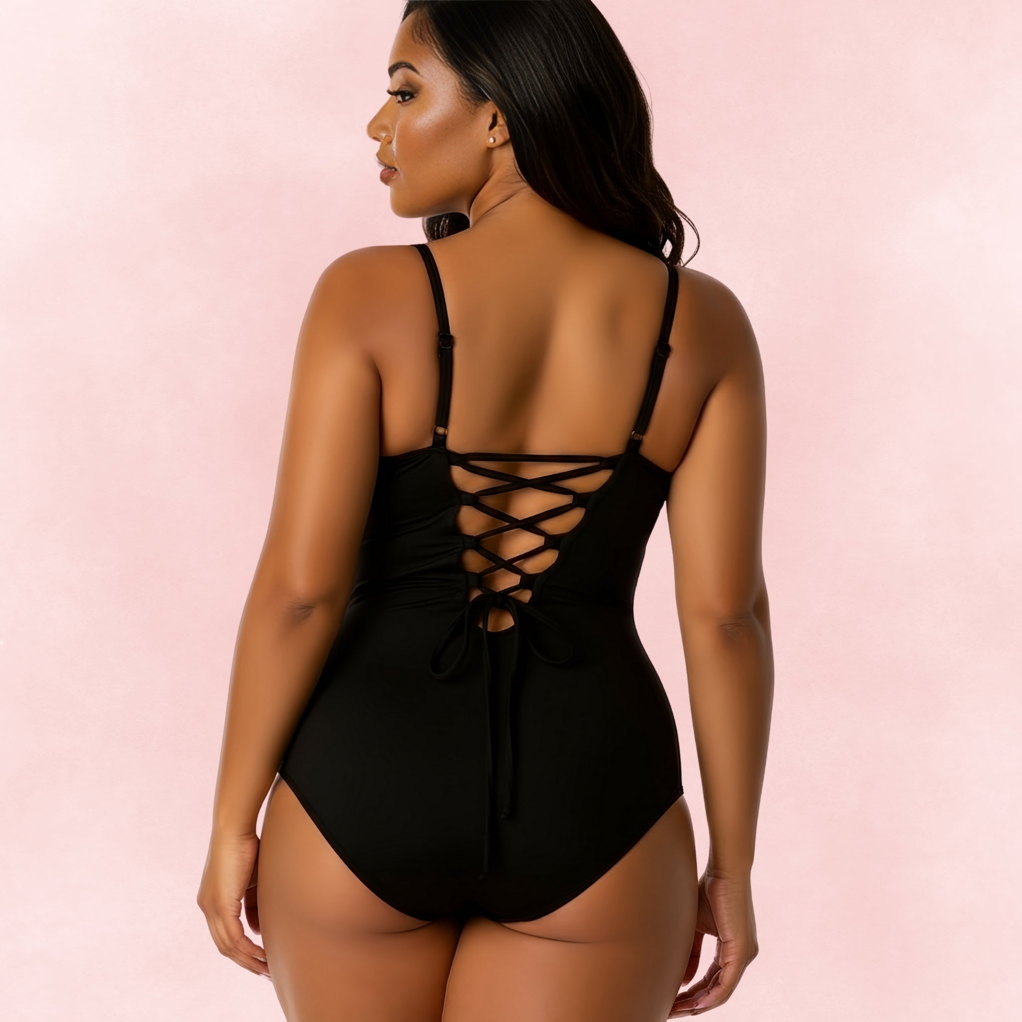 Back view of plus size black one-piece swimsuit with lace-up back and adjustable straps