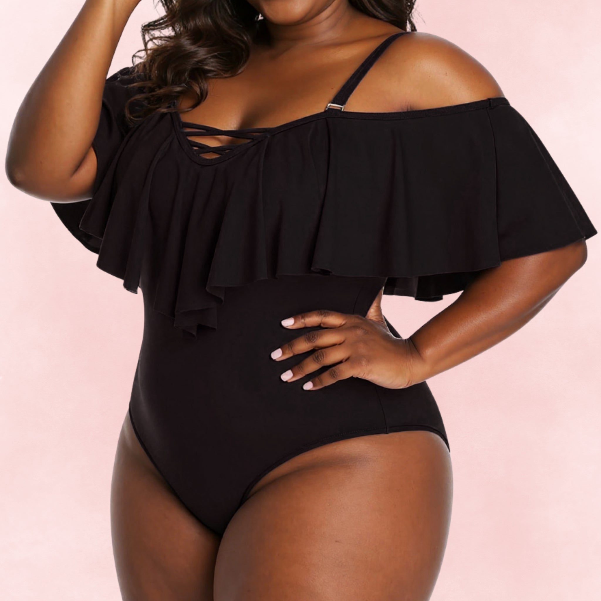 Plus size black one-piece swimsuit with off-shoulder ruffle detail and lace-up neckline