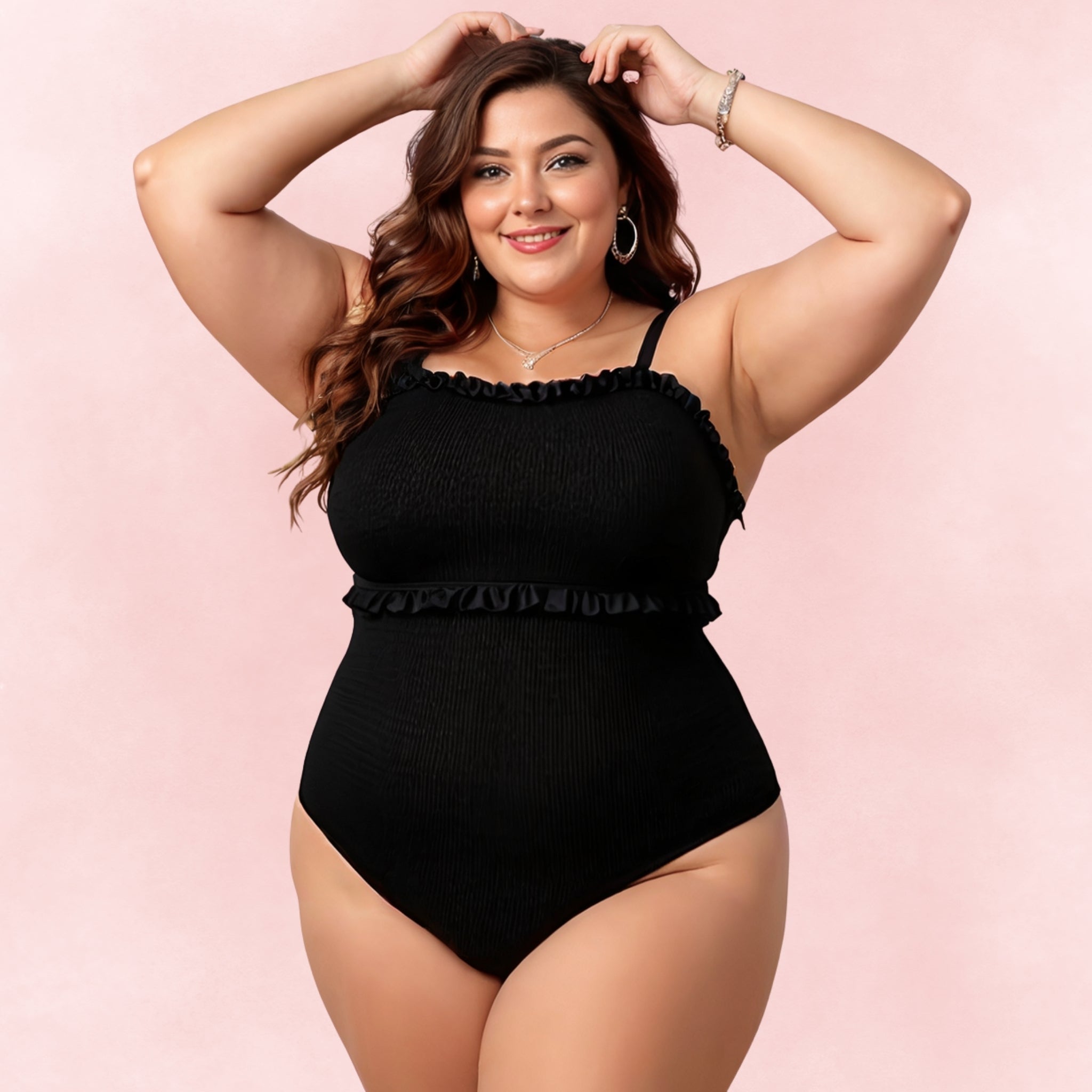 Plus size black one-piece swimsuit with smocked texture, ruffle trim and adjustable straps