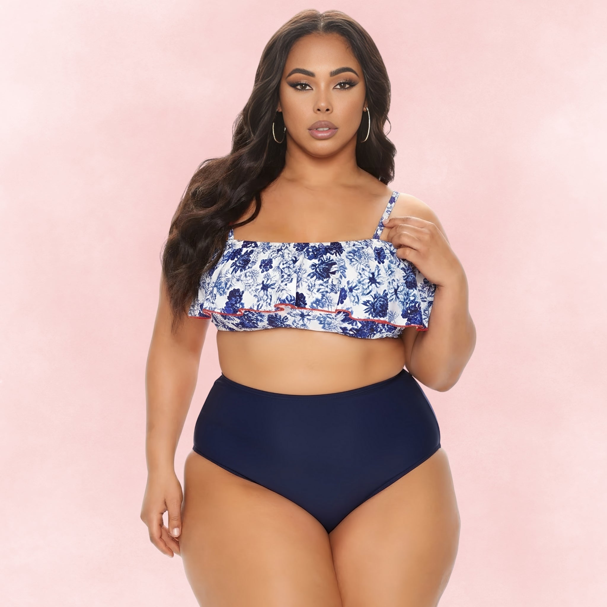 Plus size woman in blue floral off shoulder ruffle bikini top with navy high waisted bottoms, elegant beachwear.