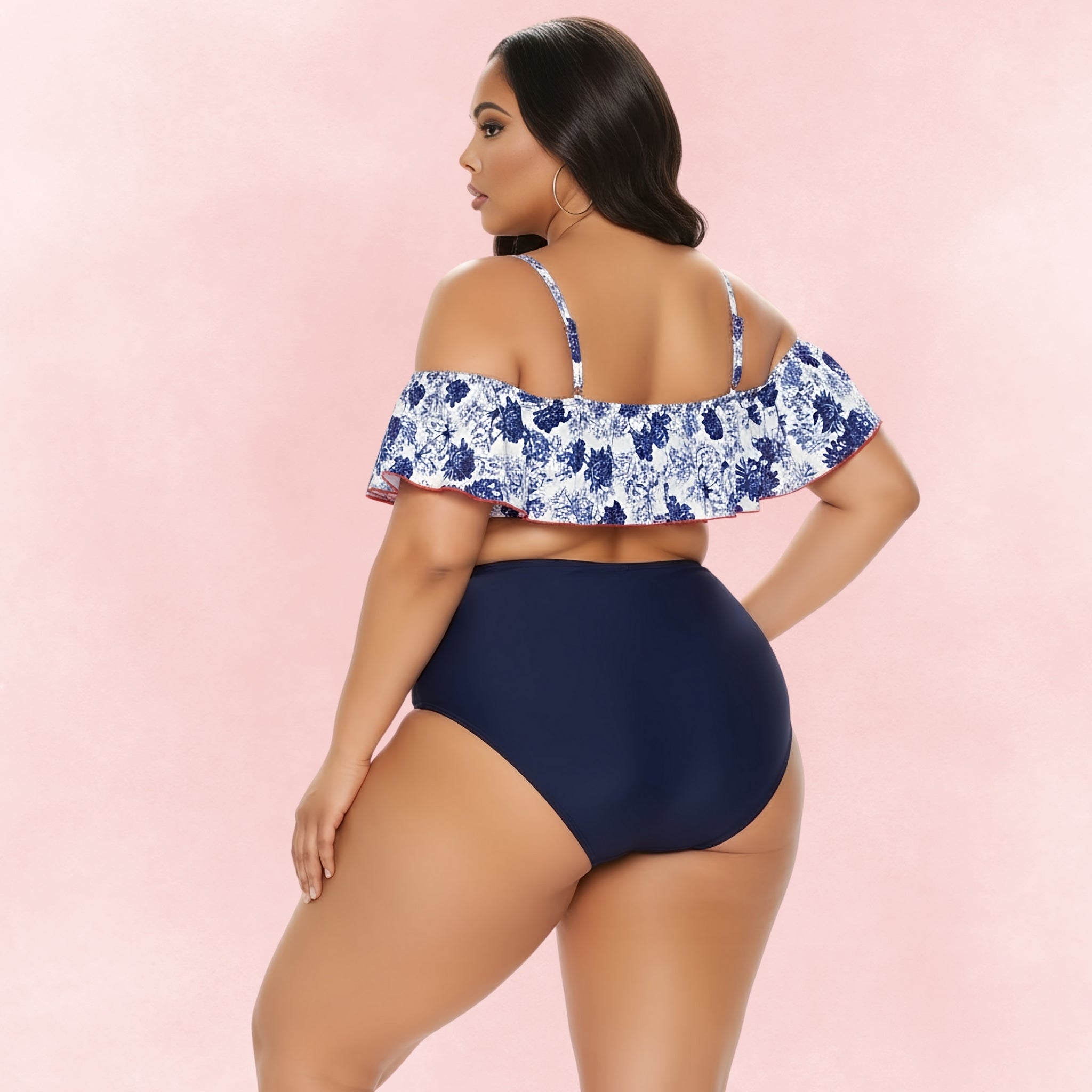 Back view of plus size model wearing blue floral ruffle bikini top with navy high waisted bottoms.