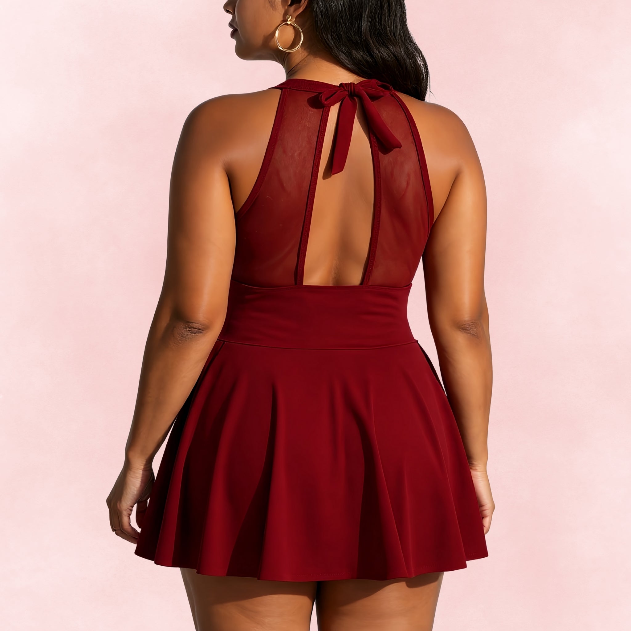 Back view of plus size burgundy halter swimdress with mesh panel and tie-back straps