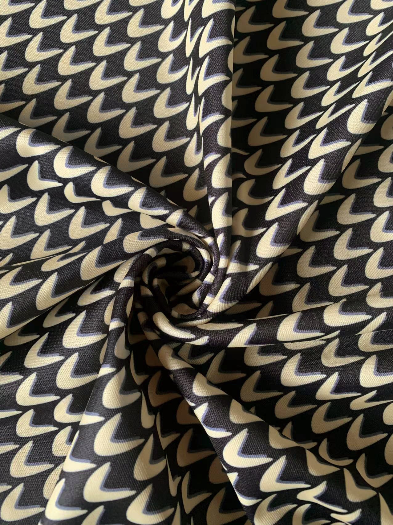 Close-up of geometric beige and black fabric used for a plus size maxi dress.