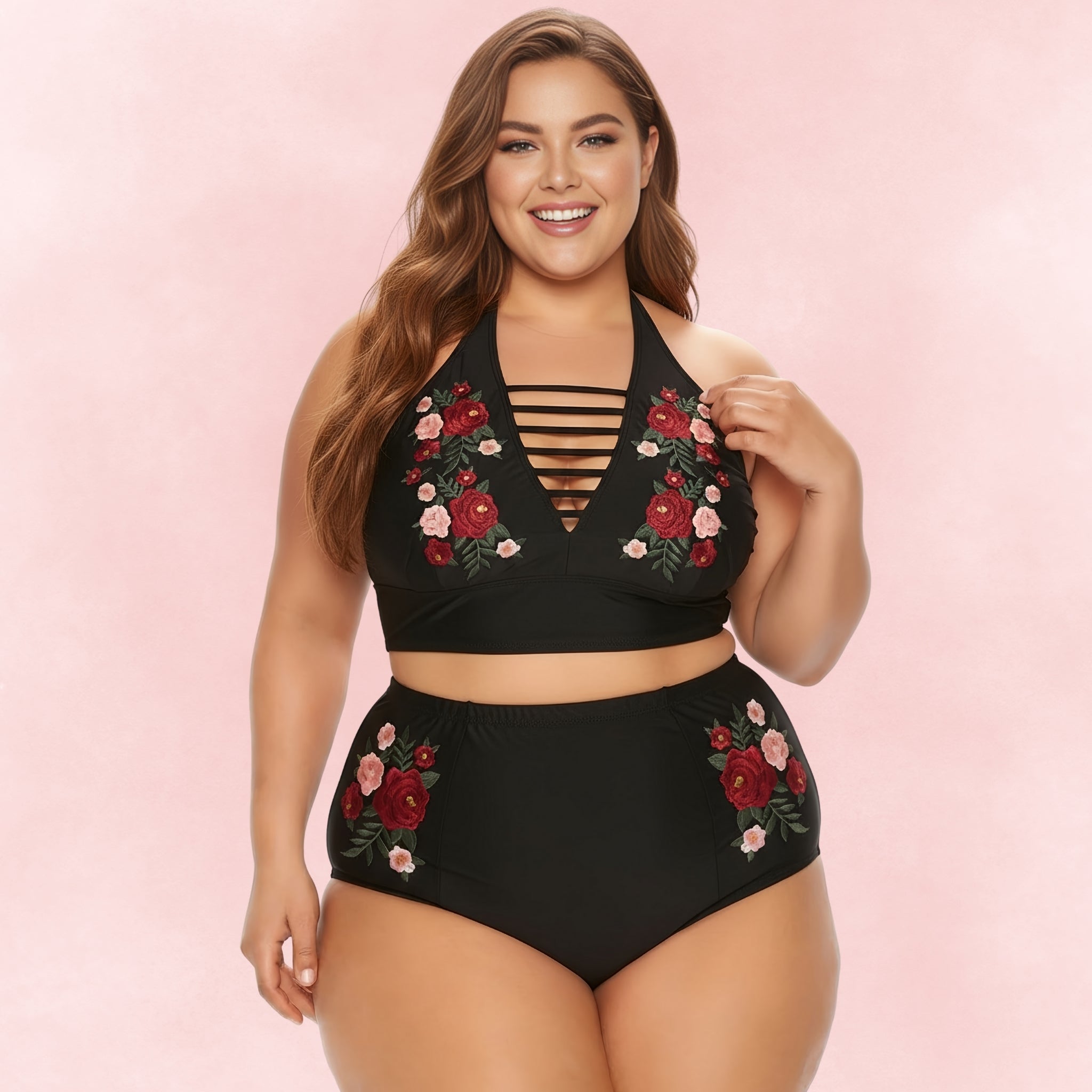 Plus size woman smiling in a black bikini set with floral embroidery and strappy halter neckline.