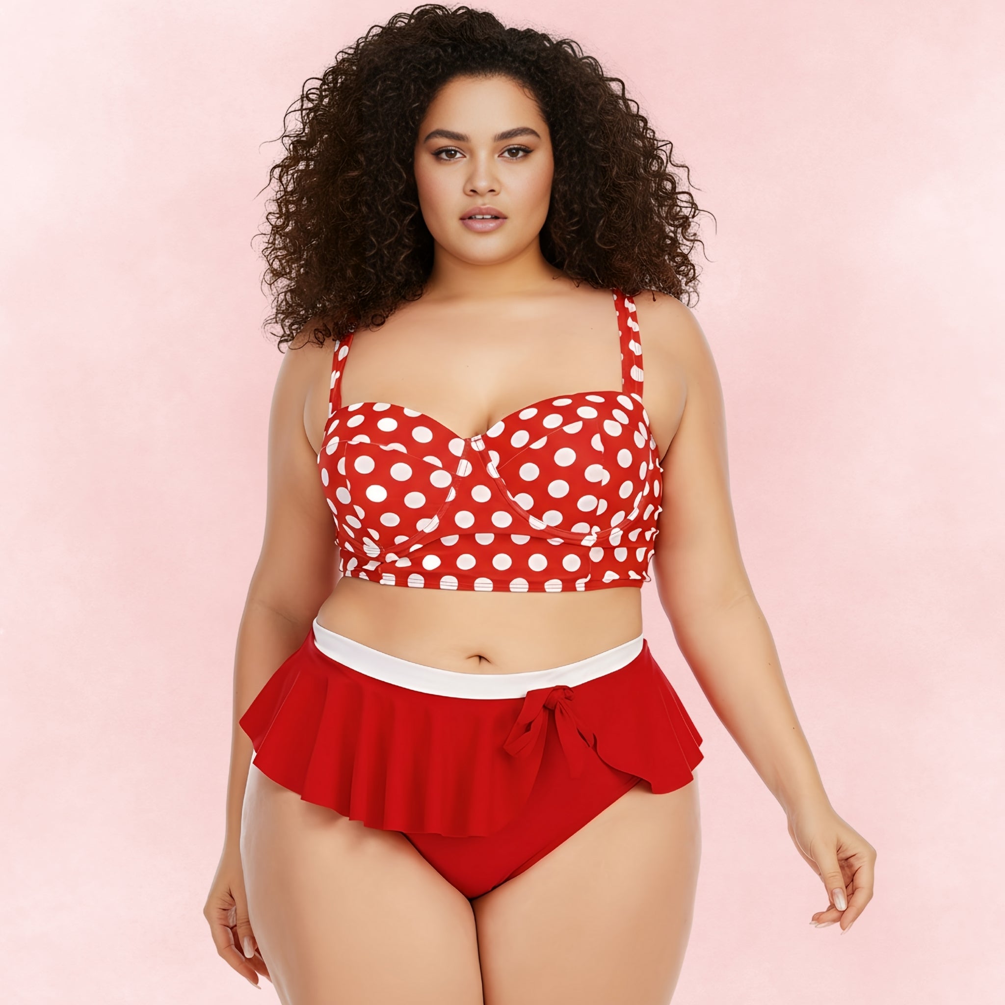 Curvy woman wearing red polka dot bikini top with bustier fit and ruffle high-waist bottoms, vintage-inspired plus size swimwear.