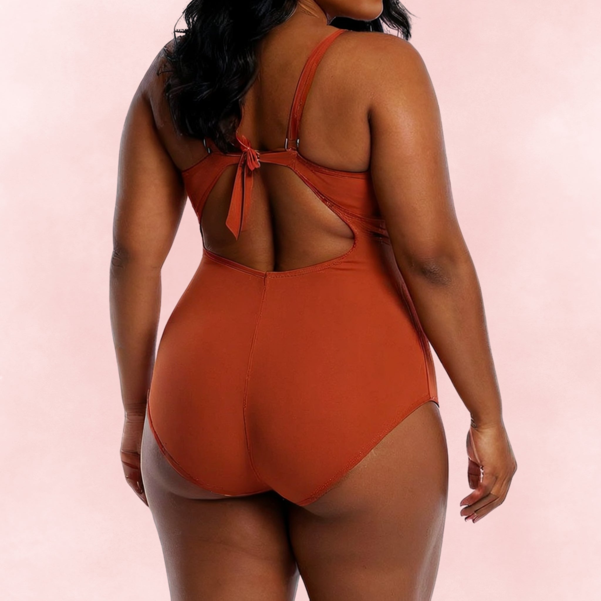 Plus size one-piece swimsuit in rust orange with tie back detail, back view