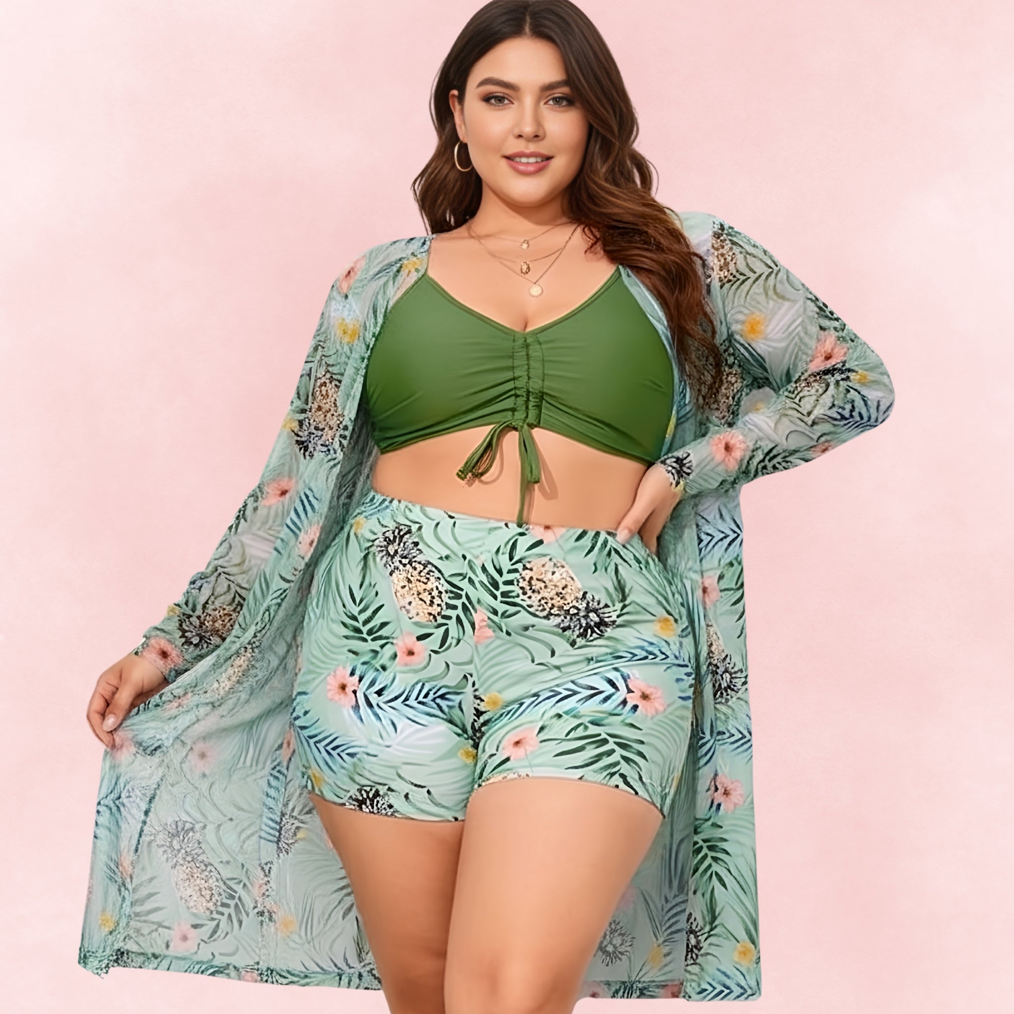 Plus-size green bikini and pineapple print swim shorts styled with a matching tropical sheer cover-up.