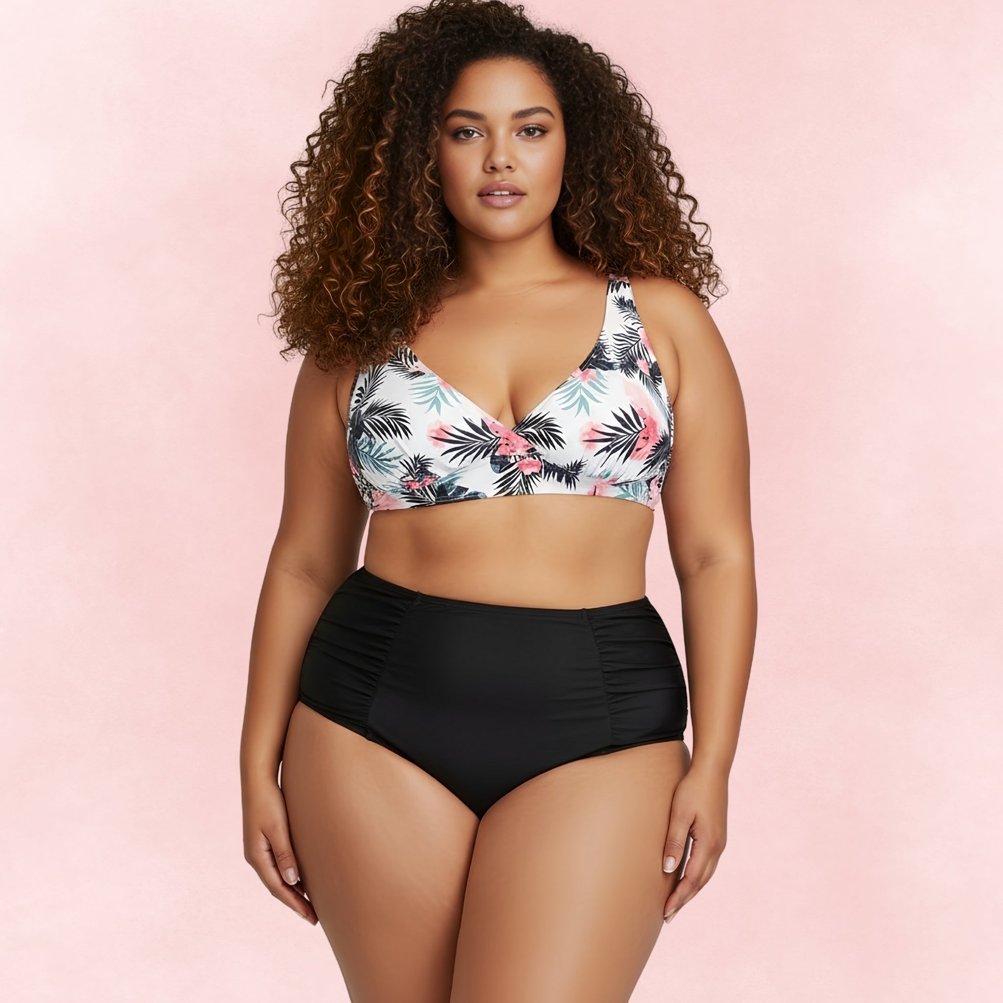ront view of plus size woman wearing tropical print bikini top with palm leaves and flowers paired with black high waist ruched bottoms