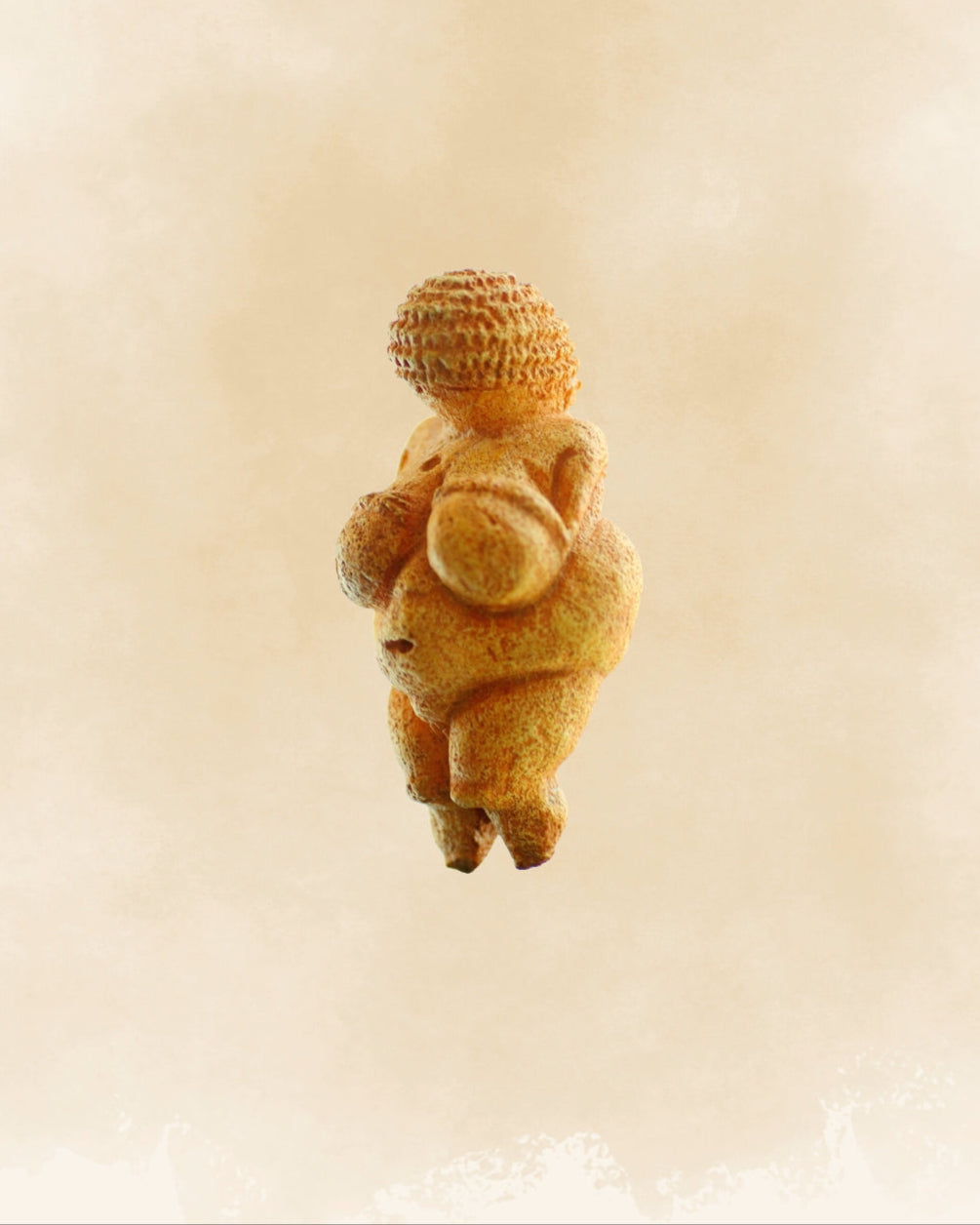 Close-up of the Venus of Willendorf, a prehistoric limestone figurine representing a fertility symbol and body positivity, displayed against a neutral background.
